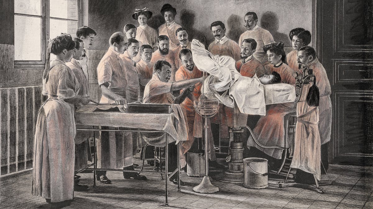 Pencil artwork drawn over an engraving of a photograph from the early 1900s which depicts a vaginal hysterectomy. The patient is lying on an operating table, her legs stirrups, covered in a white cloth. She is surrounded by 19 people who are either involved in the operation or just observing. The group is made up of mainly men. The whole scene is black and white apart from the gowns of the surgeons and observers which are tinted red.