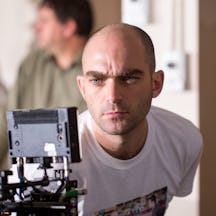 Photo of a man looking into a video monitor