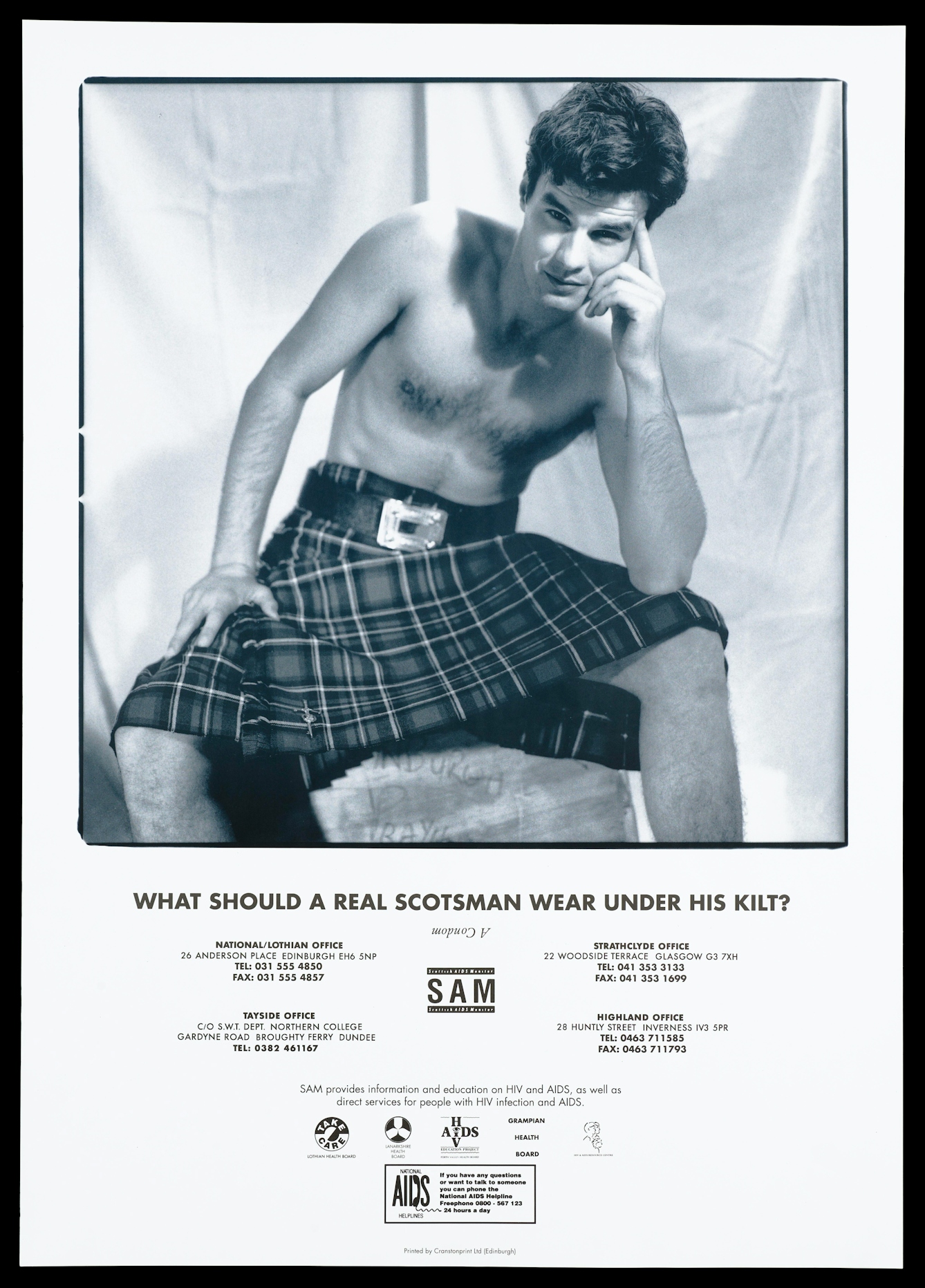 Black and white lithograph featuring a seated bare-chested man wearing a belted kilt. His left elbow rests on his knee, with his hand on his face in a pose reminscent of The Thinker by Rodin. He is smiling and his eyebrows are raised provocatively. The text under the image asks "What does a Scotsman wear under his kilt?" and provides telephone numbers for AIDS organisations and the Scottish Aids Monitor logo. 