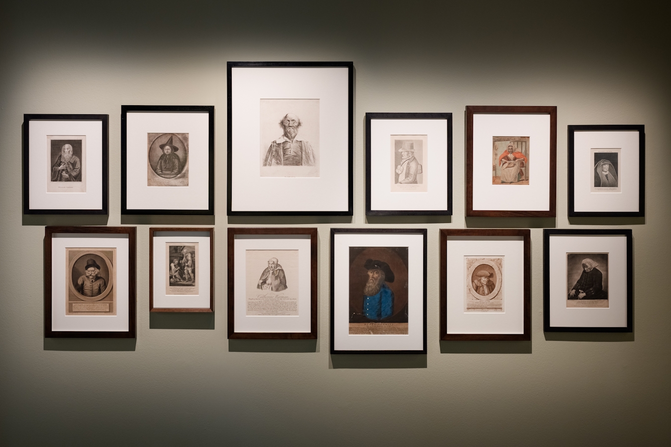 Gallery wall of painted and illustrated portraits.