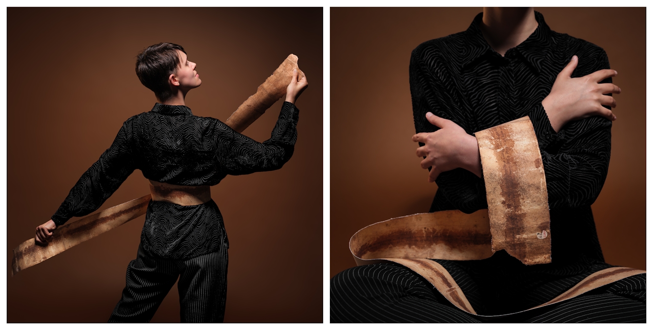 Photographic diptych, showing Kierri on the left, facing away from the camera holding either end of the facsimile birthing scroll tight, as it loops around their waist. On the right is a close up of Kierri seated cross legged on the floor, the facsimile scroll is concertinaed over their lap and looped over their folded arms.
