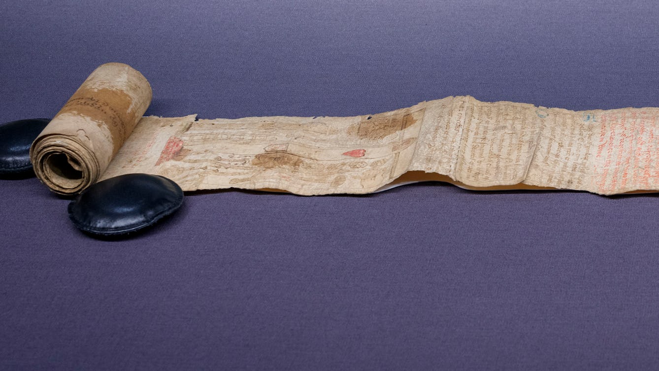 A partially unrolled parchment scroll with faded text, images and stains on its surface, from c1500 CE. Featured in an exhibition at Wellcome Collection: 'Expecting: Birth, Belief and Protection', 24 October 2025 – 19 April 2026.