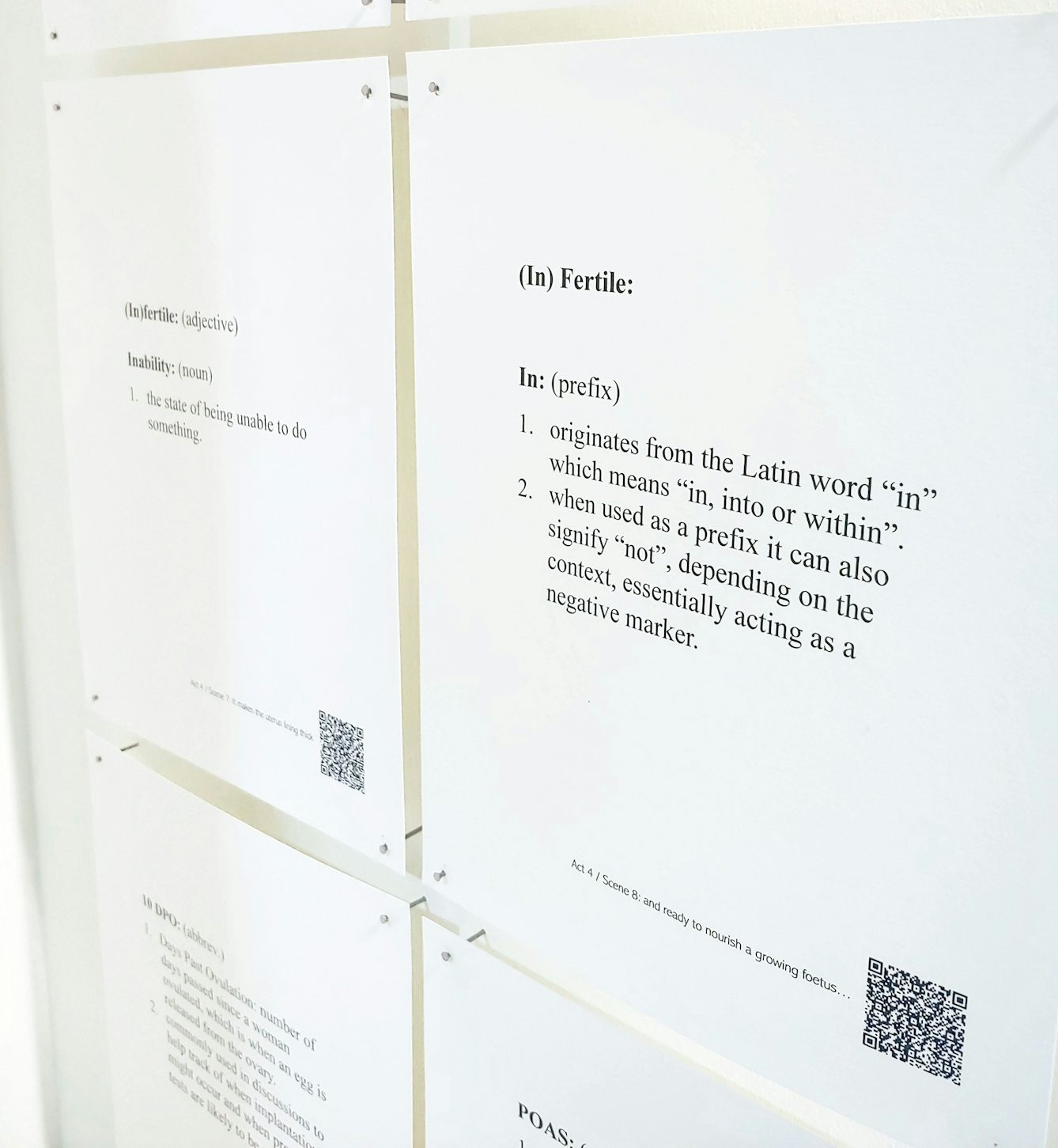 Detail of printed pages of text mounted on a wall. They include a medical devinition of infertility. The text reads:

"(In)Fertile: In: (prefix)

1. originates from the Latin word "in" which means "in, into or within".

2. When used as a prefix it can also signify "not", depending on the context, essentially acting as a negative marker."